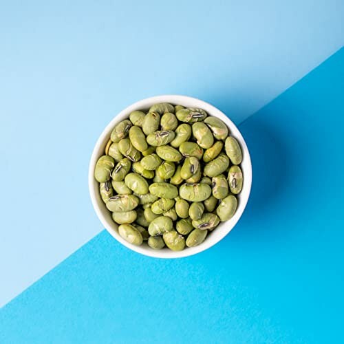 Bowl of green beans on a blue background.